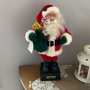 NOEL Santa Clause carries toy bag and candy cane. Plays Holliday Music tunes!